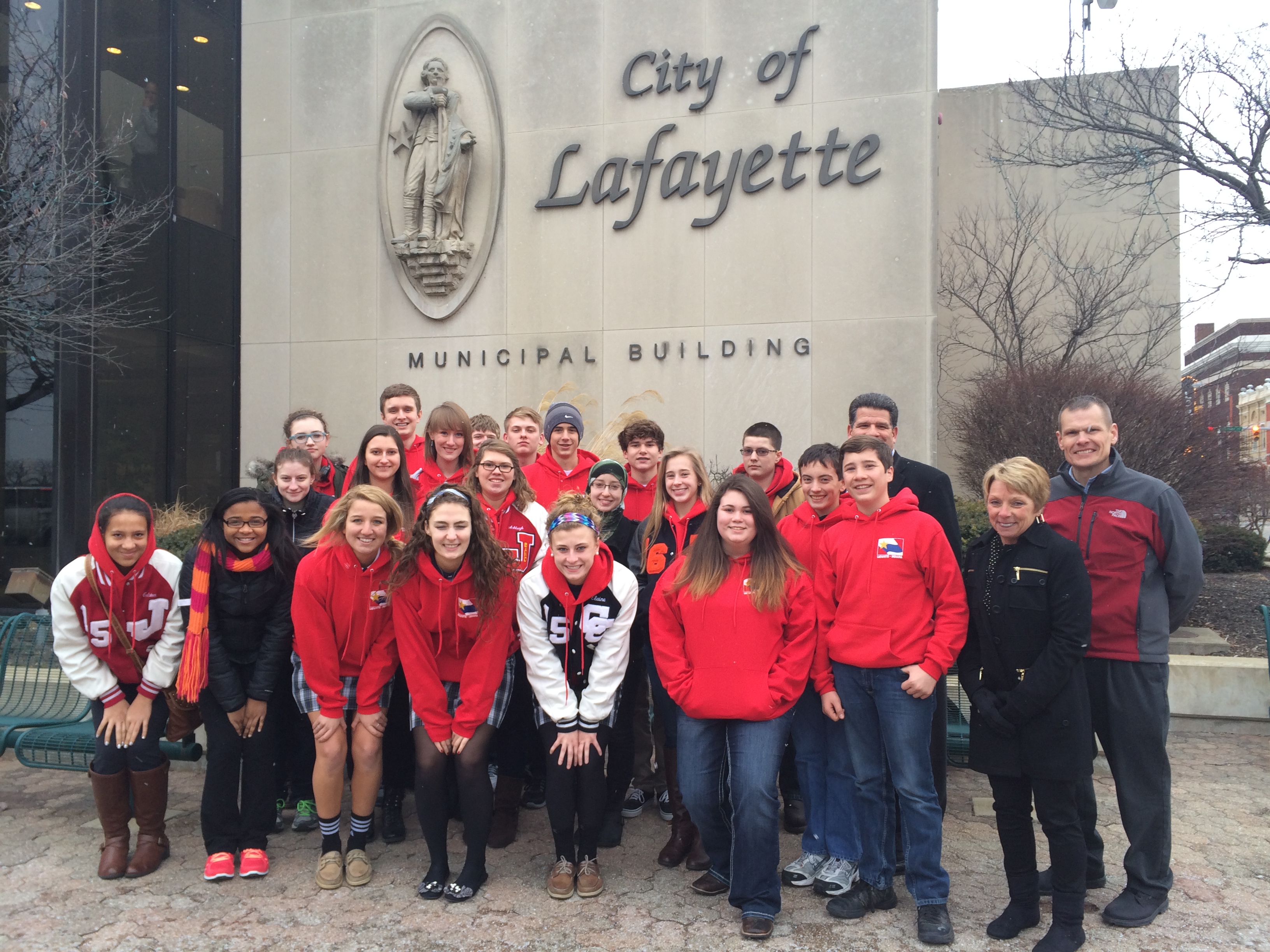 A group of teenagers standing in fron of the City of Lafayette sign